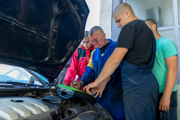 An instructor demonstrates advanced diagnostics on a car engine at our auto mechanic school