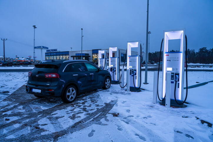 A hybrid car charging at a public charging station in Canada, to be explored in hybrid and electrical mechanic training